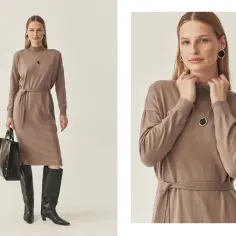 Kobieta w brązowej sukience dzianinowej, czarnych kozakach i z torebką.